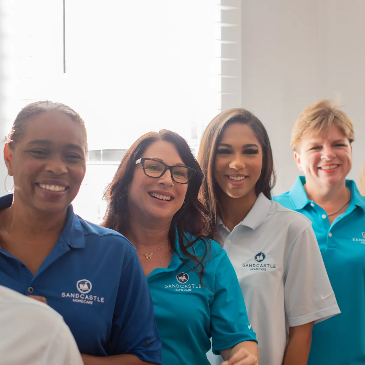 Four smiling members of the Sandcastle team
